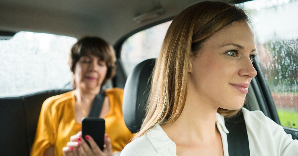 close up of driver and backseat passenger in a vehicle