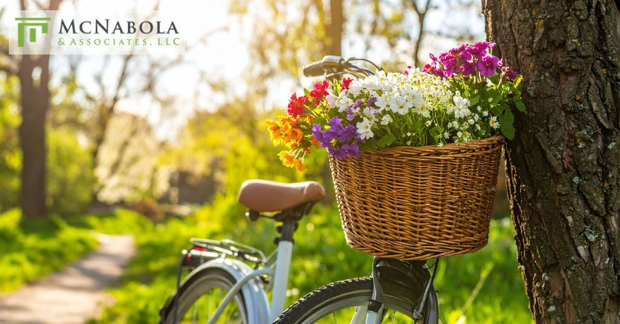bicycle carrying flowers parked by the tree